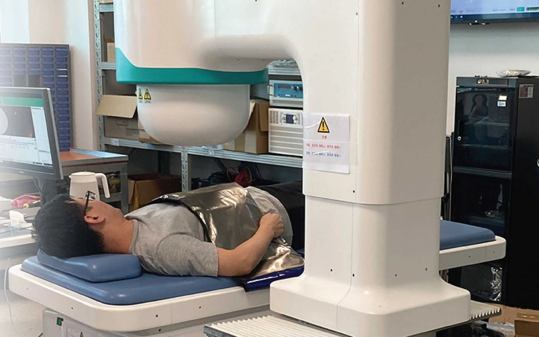 A person lies on a medical device, possibly a Sibionics blood glucose monitor, in a lab setting. Keywords: Sibionics, blood glucose monitor, medical device.