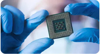 Sibionics glucose monitor chip held by gloved hands. Precise tech component.